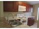 Kitchen featuring a double sink, white appliances, and plenty of cabinet space at 261 Autumn Ln # 4, Kissimmee, FL 34743