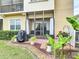 Charming backyard patio with lush landscaping, complete with a grill, seating, and beautiful plantings at 2833 Oakwater Dr # 169, Kissimmee, FL 34747