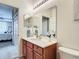 Well-maintained bathroom with a vanity, large mirror, and access to an adjacent bedroom at 2833 Oakwater Dr # 169, Kissimmee, FL 34747