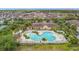 Aerial view of the community clubhouse featuring a large pool, ample seating, and lush landscaping at 2833 Oakwater Dr # 169, Kissimmee, FL 34747