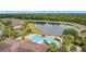 Gorgeous aerial view of community pool area with palm trees and a lake view at 2833 Oakwater Dr # 169, Kissimmee, FL 34747