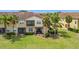 Beautifully landscaped backyard with a screened patio and ample green space, ideal for outdoor activities at 2833 Oakwater Dr # 169, Kissimmee, FL 34747
