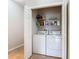 Convenient laundry closet equipped with washer, dryer, and storage shelves for efficient organization at 2833 Oakwater Dr # 169, Kissimmee, FL 34747