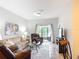 Bright living room with tile flooring, comfortable seating, and sliding glass doors to the outdoor space at 2833 Oakwater Dr # 169, Kissimmee, FL 34747