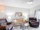 Spacious living room showcases comfortable seating, glass-topped coffee table, and neutral decor at 2833 Oakwater Dr # 169, Kissimmee, FL 34747