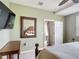 Bright bedroom featuring a ceiling fan, a TV and a mirror that reflects the bed at 2833 Oakwater Dr # 169, Kissimmee, FL 34747