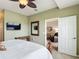 Spacious bedroom with a large bed, ceiling fan, and a door leading to the living area at 2833 Oakwater Dr # 169, Kissimmee, FL 34747
