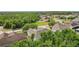 Aerial view of home in residential neighborhood with lush landscaping and mature trees at 3209 Eagle Watch Dr, Kissimmee, FL 34746