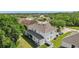 Aerial view of backyard, highlighting covered patio, lush greenery, and serene neighborhood at 3209 Eagle Watch Dr, Kissimmee, FL 34746