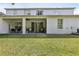 Large backyard featuring a covered patio, mature trees, and well-maintained lawn at 3209 Eagle Watch Dr, Kissimmee, FL 34746