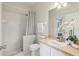 Bright bathroom featuring tiled shower, modern fixtures, and stylish vanity with lots of light at 3209 Eagle Watch Dr, Kissimmee, FL 34746