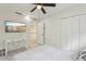 Bright bedroom with a ceiling fan, neutral tones, and a door to the upper hallway at 3209 Eagle Watch Dr, Kissimmee, FL 34746