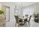Bright dining room with modern chandelier, large windows, and elegant table setting for four at 3209 Eagle Watch Dr, Kissimmee, FL 34746