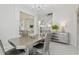 Elegant dining room with modern table set, stylish buffet, and open floor plan leading to the staircase at 3209 Eagle Watch Dr, Kissimmee, FL 34746