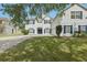 Charming two-story home featuring a brick driveway, beautiful lawn, and dark blue shutters at 3209 Eagle Watch Dr, Kissimmee, FL 34746
