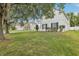 Charming home with blue shutters, a spacious front lawn, and mature trees at 3209 Eagle Watch Dr, Kissimmee, FL 34746
