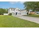 Beautiful two-story home with blue shutters, a well-maintained lawn, and paver driveway at 3209 Eagle Watch Dr, Kissimmee, FL 34746