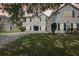 Charming two-story home with a brick driveway, well-manicured lawn, and white stucco exterior at 3209 Eagle Watch Dr, Kissimmee, FL 34746