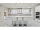 Modern kitchen with island, white cabinetry, pendant lighting, stainless steel appliances, and breakfast bar at 3209 Eagle Watch Dr, Kissimmee, FL 34746