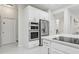 Close-up of modern kitchen with stainless steel appliances, white cabinets, and a breakfast bar at 3209 Eagle Watch Dr, Kissimmee, FL 34746