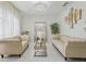 Elegant living room featuring tufted sofas, a modern chandelier, and neutral décor at 3209 Eagle Watch Dr, Kissimmee, FL 34746