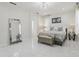 Inviting main bedroom with a crystal chandelier, comfortable bed, and ample natural light at 3209 Eagle Watch Dr, Kissimmee, FL 34746