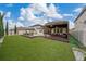 Spacious backyard with covered patio, artificial turf, and pool at 3240 Preserve Dr, Orlando, FL 32824
