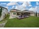 Landscaped backyard with a large pool and pergola at 3240 Preserve Dr, Orlando, FL 32824
