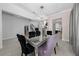Bright dining room with a mirrored table and crystal chandelier at 3240 Preserve Dr, Orlando, FL 32824
