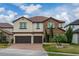 Two-story house with stone accents and a two-car garage at 3240 Preserve Dr, Orlando, FL 32824