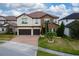 Two-story house with stone accents and a two-car garage at 3240 Preserve Dr, Orlando, FL 32824