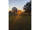 Scenic sunset view over a tranquil landscape with lush greenery at 3449 N Canoe Creek Rd, Kenansville, FL 34739