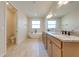 Elegant bathroom with double vanity, soaking tub, and walk-in shower at 3449 N Canoe Creek Rd, Kenansville, FL 34739