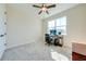 Bright bedroom with ceiling fan, large window, and workspace at 3449 N Canoe Creek Rd, Kenansville, FL 34739