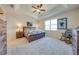 Spacious bedroom with carpeted floor, ceiling fan, and ample natural light at 3449 N Canoe Creek Rd, Kenansville, FL 34739