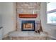 Stone fireplace with a wooden mantel in the living room at 3449 N Canoe Creek Rd, Kenansville, FL 34739