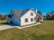 Two-story home with attached garage, gray roof, and landscaped yard at 3449 N Canoe Creek Rd, Kenansville, FL 34739