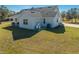 Craftsman style home with gray roof, white siding, and a spacious lawn at 3449 N Canoe Creek Rd, Kenansville, FL 34739