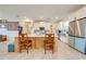 Kitchen island with seating, white cabinets, and stainless steel appliances at 3449 N Canoe Creek Rd, Kenansville, FL 34739
