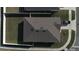Birds eye view of a house, its roof, driveway, and surrounding landscaping at 401 Chayne Pl, St Cloud, FL 34771