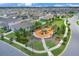 A neighborhood aerial showcases the community playground with surrounding houses, trees, and sidewalks at 401 Chayne Pl, St Cloud, FL 34771