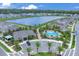 An aerial view showcases the community pool and clubhouse with palm trees, landscaping, and parking at 401 Chayne Pl, St Cloud, FL 34771