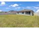The expansive backyard of this home has a screened-in porch and white fencing at 401 Chayne Pl, St Cloud, FL 34771