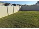 Spacious backyard enclosed by a white vinyl fence, offering a private outdoor space at 401 Chayne Pl, St Cloud, FL 34771