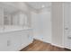 Bathroom featuring a double vanity, mirror, and walk-in shower with glass door at 401 Chayne Pl, St Cloud, FL 34771