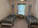 Cozy bedroom featuring two twin beds, floral themed decor and neutral carpet at 401 Chayne Pl, St Cloud, FL 34771