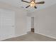 A bright bedroom features a ceiling fan and neutral walls with a carpeted floor at 401 Chayne Pl, St Cloud, FL 34771