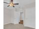 A carpeted bedroom has a ceiling fan, neutral walls and white doors at 401 Chayne Pl, St Cloud, FL 34771