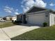 Charming single-story home features a well-maintained lawn and a two-car garage at 401 Chayne Pl, St Cloud, FL 34771