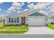 Charming single-story home features a well-maintained lawn and a two-car garage at 401 Chayne Pl, St Cloud, FL 34771